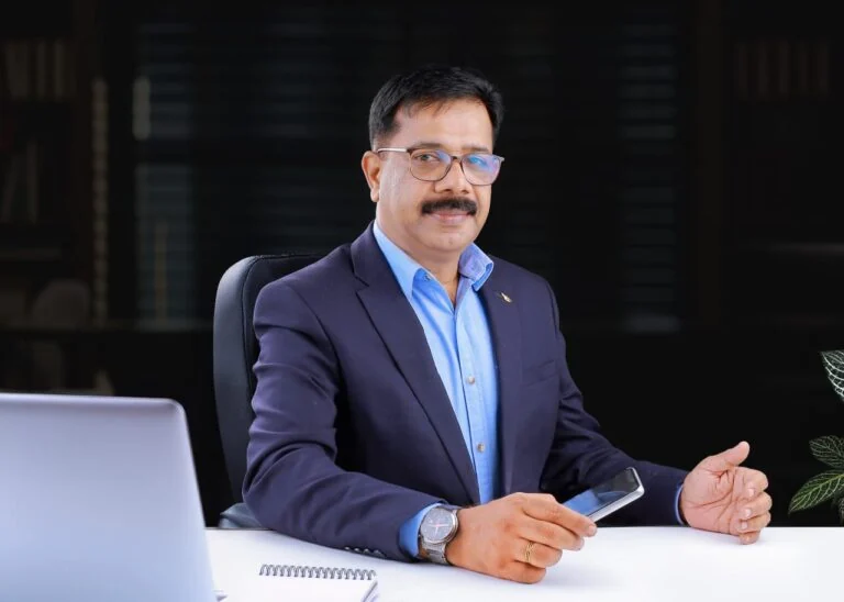 Shaji Cosmos at his desk