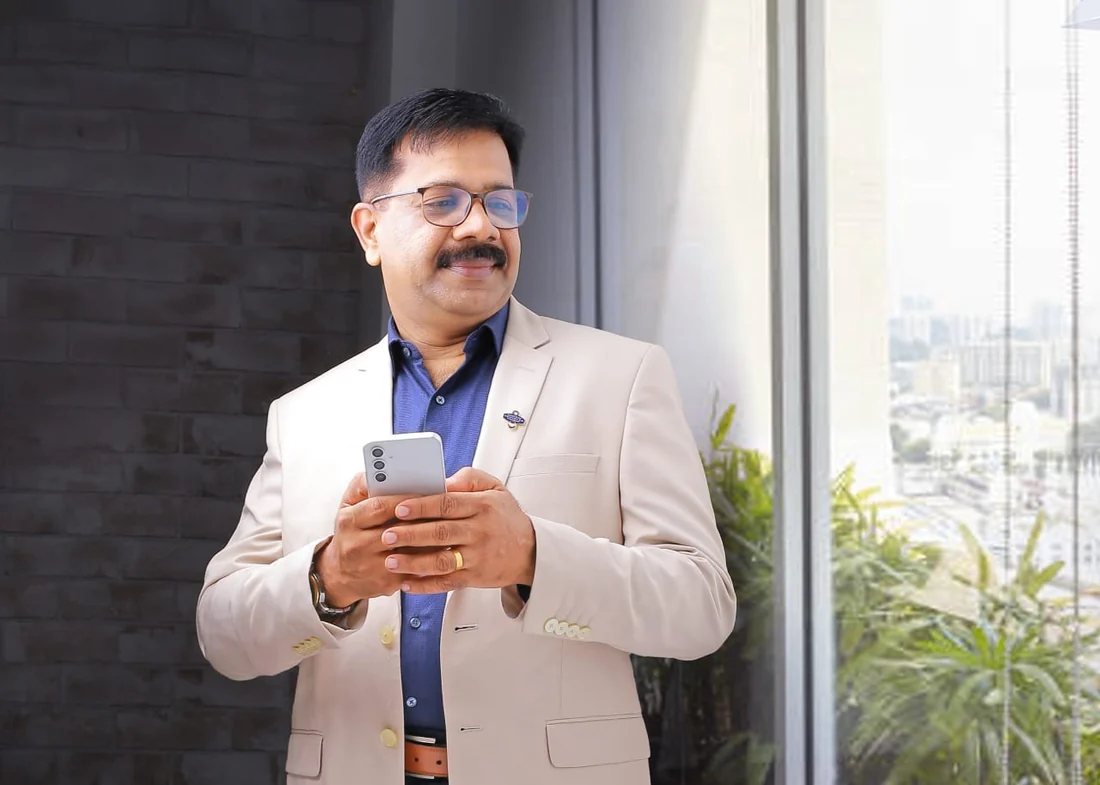 Shaji Cosmos standing near a window